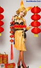 A woman dressed in a chinese costume holding a red lantern.